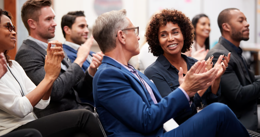Business People Applauding at Conference
