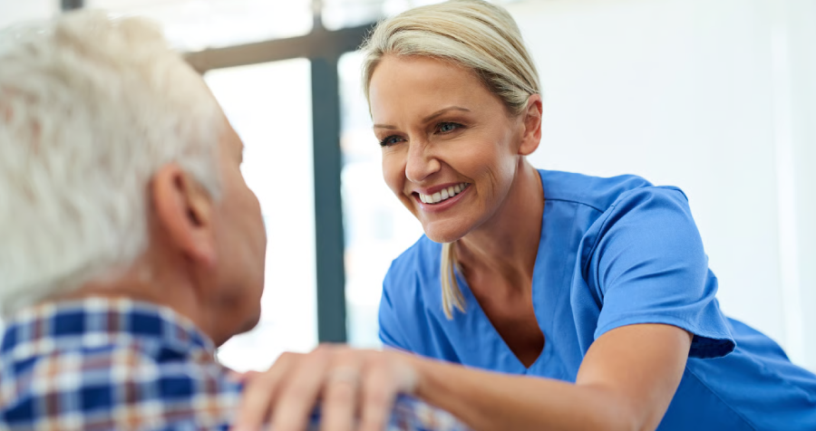 Caring Woman Comforts Senior Man in Hospital