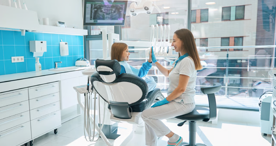 Dentist and Child Giving High Five in Office