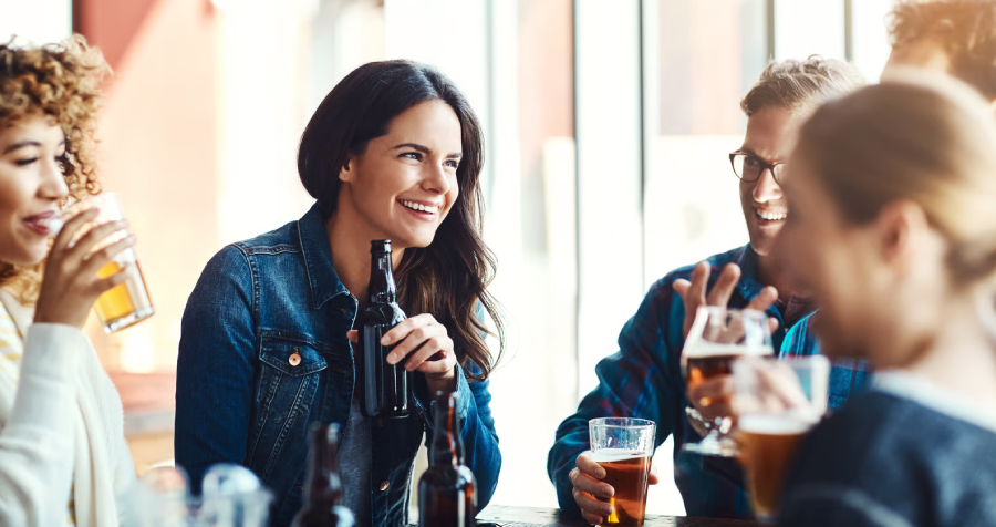 Group of Friends Enjoying Drinks Together Indoors