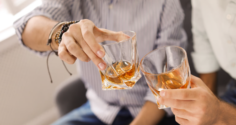 Two Men Toasting Drinks Indoors Social Gathering